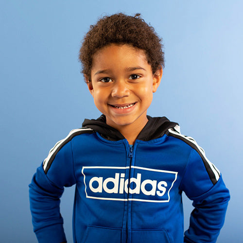 boy in blue adidas jacket